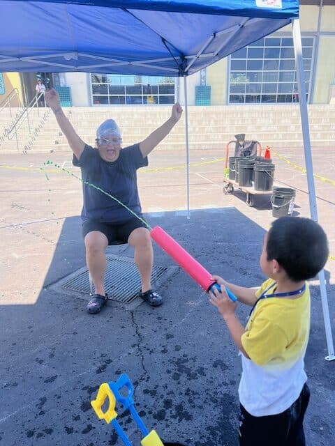 Student firing a slime cannon at Brittany